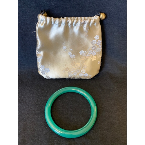 52 - A jade green coloured bangle (possibly green glass)