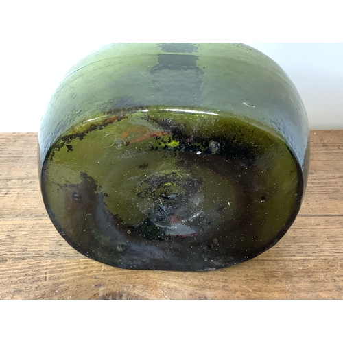 71 - A 19th Century bladder shape green glass large bottle with mould lines, approx. 11 3/4