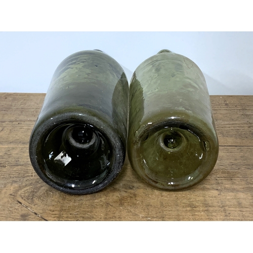 72 - Two large 19th Century green glass bottles with heavy indented 'push up' bases, the largest 15 3/4