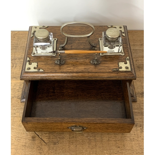 94 - A Victorian oak double writing/ink stand with white metal mounts and drawer under, 13 1/4