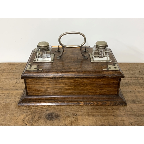 94 - A Victorian oak double writing/ink stand with white metal mounts and drawer under, 13 1/4