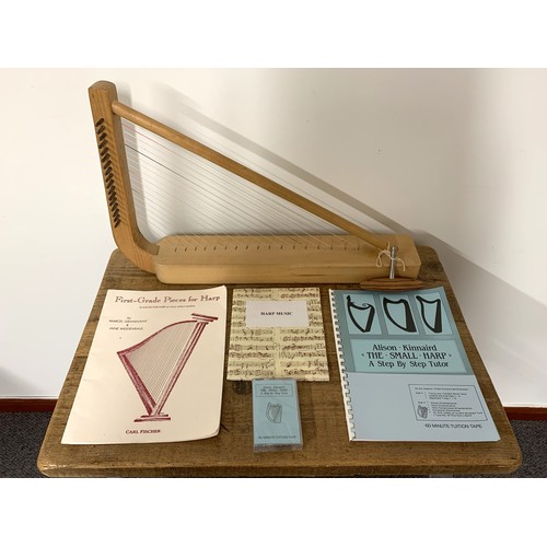 215 - A lap harp with related music sheets, cassette etc