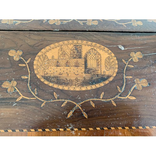 90 - A Victorian inlaid wood fall front writing slope with lift lid, inlaid with a building and floral de... 