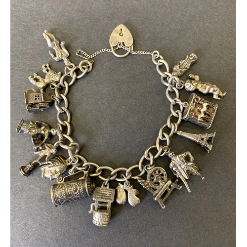 102 - A vintage silver charm bracelet with a series of white metal charms, but it does include a Georg Jen... 