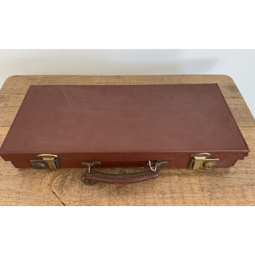 131 - A leather case with Masonic regalia to include a halter, a silver medal, a book and paperwork