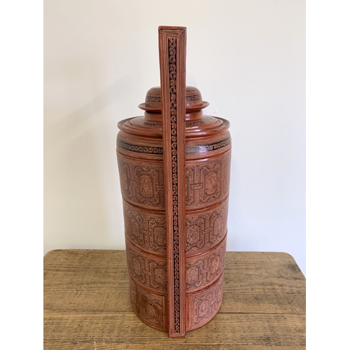 134 - A vintage Burmese Myanmar red lacquer four section food basket/cannisters, hand painted decoration, ... 