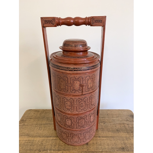 134 - A vintage Burmese Myanmar red lacquer four section food basket/cannisters, hand painted decoration, ... 