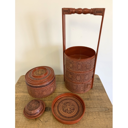 134 - A vintage Burmese Myanmar red lacquer four section food basket/cannisters, hand painted decoration, ... 