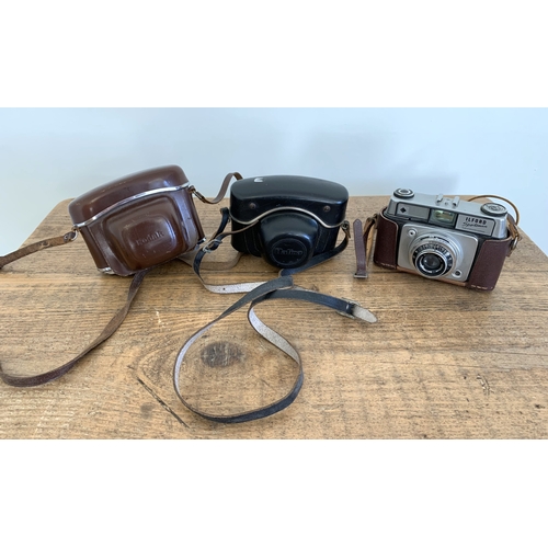 166 - Three vintage cameras to include a Kodak Retina Automatic in its case, a vintage Halina Paulette 196... 