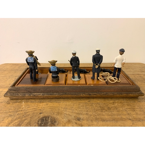 209 - A diorama of vintage soldiers, sailors and two Jaguar cats on a plinth with a perspex cover, (dirty ... 