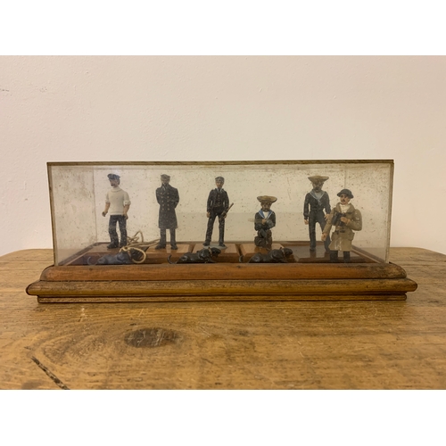 209 - A diorama of vintage soldiers, sailors and two Jaguar cats on a plinth with a perspex cover, (dirty ... 