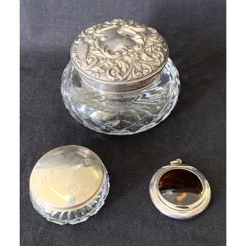 238 - A hallmarked silver and cut glass dressing table jar, the lid decorated with birds and inset with a ... 