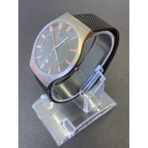 265 - A Skagen mens titanium grey orange wristwatch (running at the time of lotting)