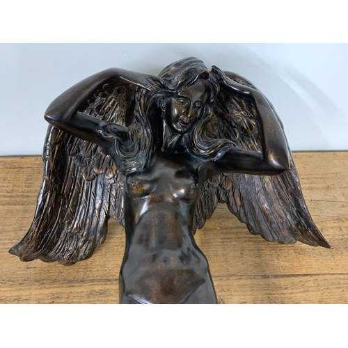 330 - A large resin figure of an angel 'Descending Night', 23