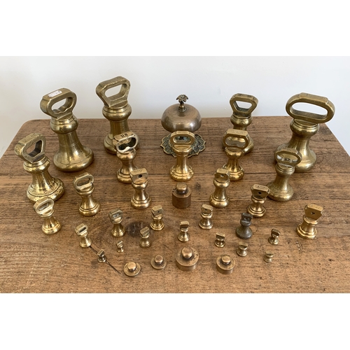 46 - A selection of vintage brass weights including large Avery examples plus a brass desk bell