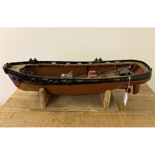 64 - A small vintage remote controlled boat, hull only (inside as found, no controller), 24