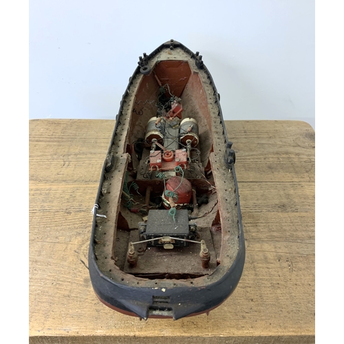 64 - A small vintage remote controlled boat, hull only (inside as found, no controller), 24