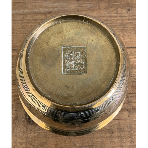 146 - An antique Chinese brass jardiniere, character marks to base and decorated with dragons, 8 1/2