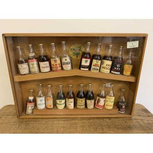 1 - A vintage purpose made wood and glass display case for 'Keo Miniature Spirits', various bottles (som... 