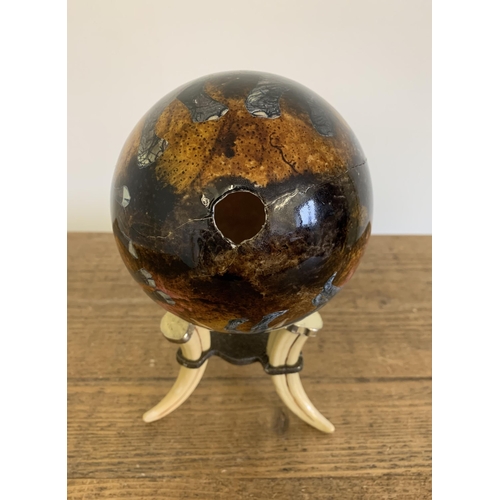 283 - A decoupage ostrich egg decorated with African animals on a faux tusk stand, 9 1/4