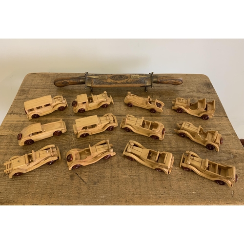 308 - A mixed lot of wooden cars, twelve in total plus an Indian knife and fork carving set