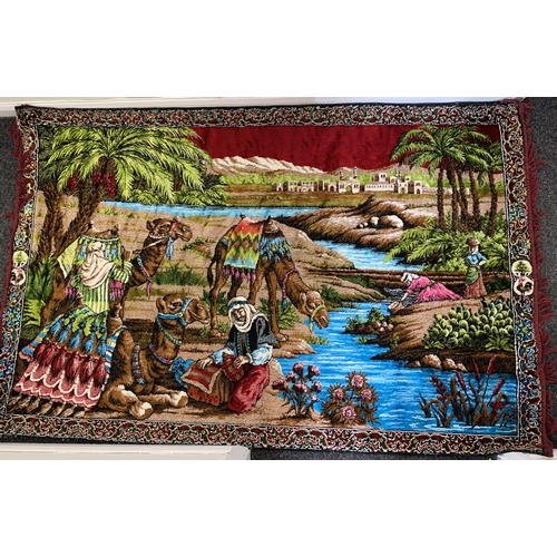 310 - A vintage brightly coloured floor rug with camels by a river, 71