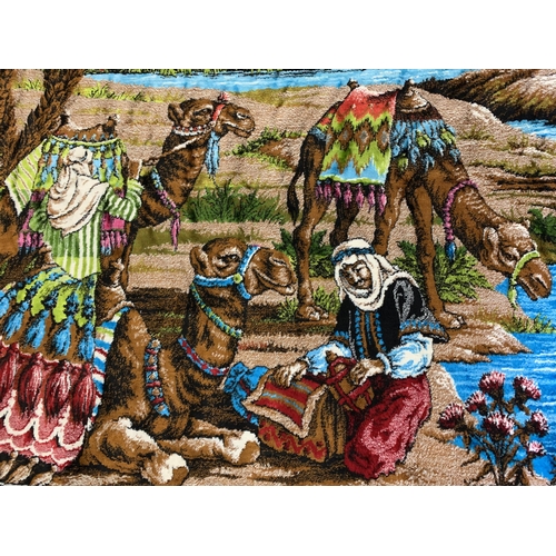 310 - A vintage brightly coloured floor rug with camels by a river, 71