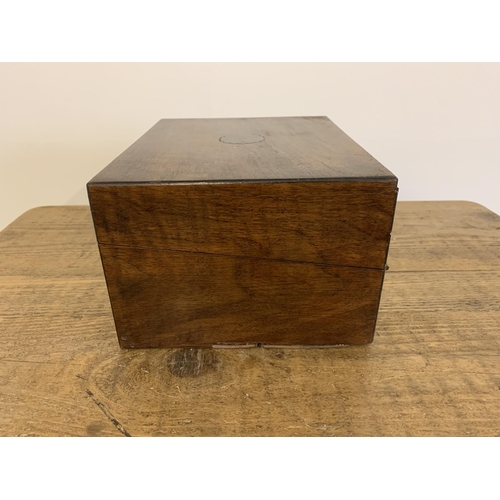 12 - A small antique mahogany writing slope/box inset with a brass cartouche and lock (no key), 10