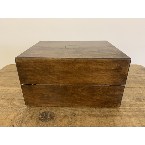 12 - A small antique mahogany writing slope/box inset with a brass cartouche and lock (no key), 10