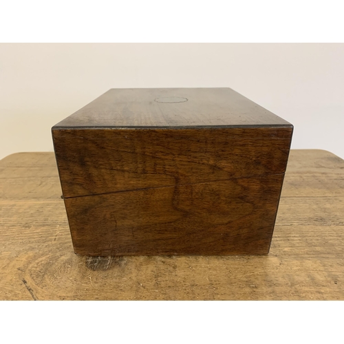 12 - A small antique mahogany writing slope/box inset with a brass cartouche and lock (no key), 10