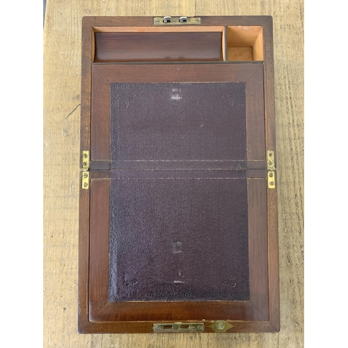 12 - A small antique mahogany writing slope/box inset with a brass cartouche and lock (no key), 10