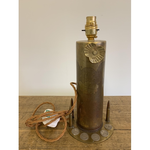 123 - A Trench Art shell turned into a working lamp, dummy bullets and five silver shillings dated  from 1... 