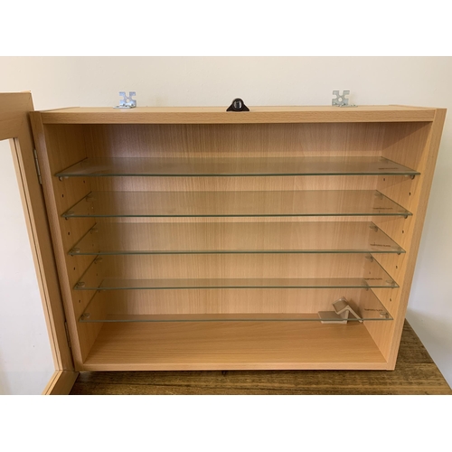 219 - A small display cabinet with glass shelves for displaying toy cars and buses etc, 24 1/2