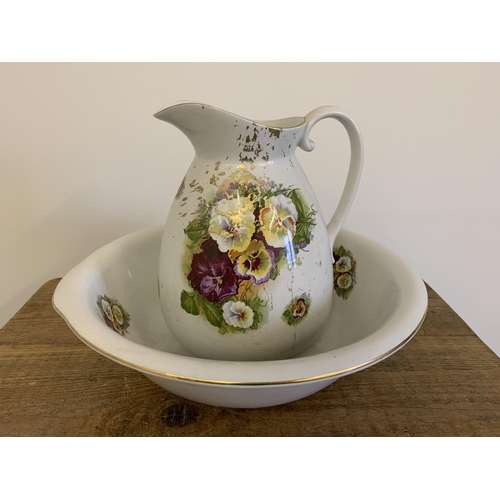 30 - An early 20th Century Empire & Co Stoke-on-Trent jug and bowl decorated with pansies