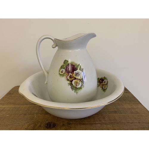 30 - An early 20th Century Empire & Co Stoke-on-Trent jug and bowl decorated with pansies