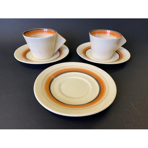 42 - A pair of Clarice Cliff Bizarre pattern cups and saucers plus a spare saucer (crazing to glaze, slig... 