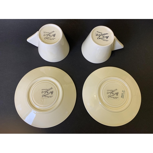 42 - A pair of Clarice Cliff Bizarre pattern cups and saucers plus a spare saucer (crazing to glaze, slig... 