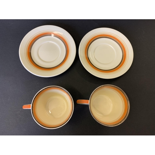 42 - A pair of Clarice Cliff Bizarre pattern cups and saucers plus a spare saucer (crazing to glaze, slig... 