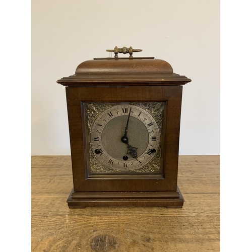 51 - A mahogany case mantel clock with key, marked for Garrard & Co Ltd with dedication, undated presenta... 