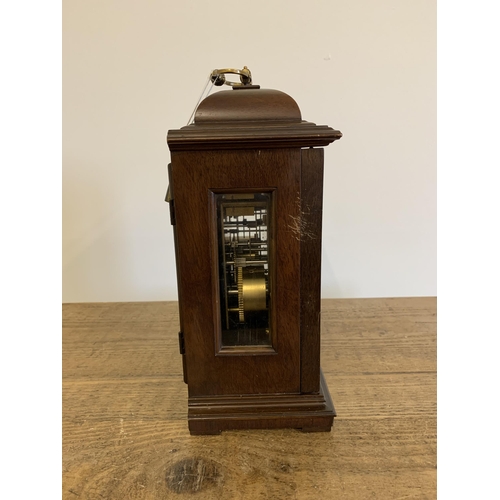 51 - A mahogany case mantel clock with key, marked for Garrard & Co Ltd with dedication, undated presenta... 