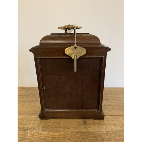 51 - A mahogany case mantel clock with key, marked for Garrard & Co Ltd with dedication, undated presenta... 