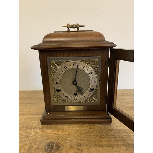 51 - A mahogany case mantel clock with key, marked for Garrard & Co Ltd with dedication, undated presenta... 