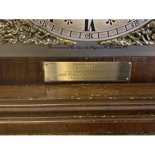 51 - A mahogany case mantel clock with key, marked for Garrard & Co Ltd with dedication, undated presenta... 