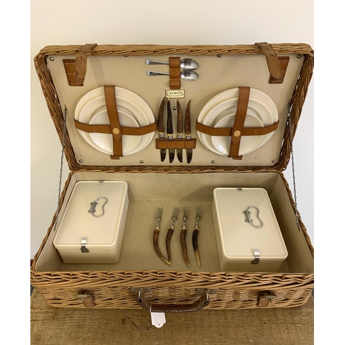 65 - A vintage 'Coracle' wicker picnic basket with original sandwich boxes, horn handle cutlery, plates e... 