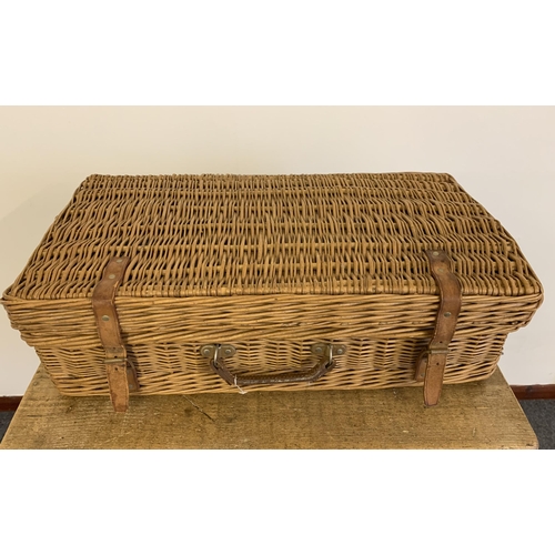 65 - A vintage 'Coracle' wicker picnic basket with original sandwich boxes, horn handle cutlery, plates e... 