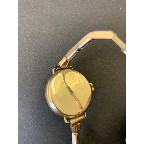 93 - A 9ct gold case ladies 'Clawsman' wristwatch with yellow metal elasticated strap (lacking one hand, ... 