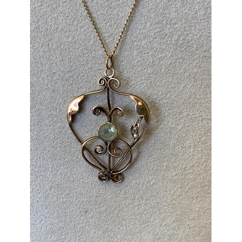 97 - A yellow metal Art Nouveau pendant with central stone and pearl set (one pearl missing) on a fine 16... 