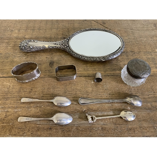 101 - A selection of hallmarked silver items including a hand mirror, napkin rings, spoons etc