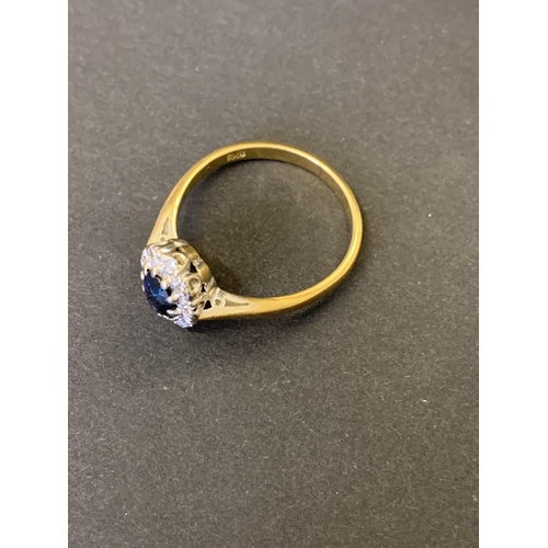 123 - An 18ct gold and sapphire set ring with diamond surround, approx. size Q, weight approx. 3.8g (chip ... 