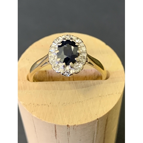 123 - An 18ct gold and sapphire set ring with diamond surround, approx. size Q, weight approx. 3.8g (chip ... 